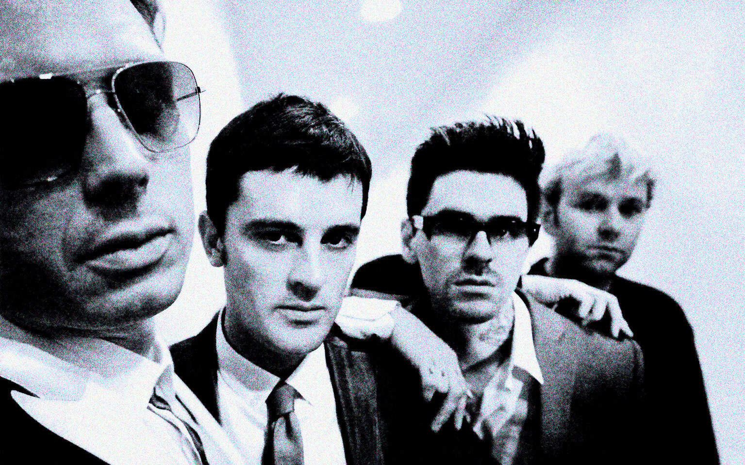 Vintage band members in black-and-white portrait, showcasing music history, news, and cultural moments.