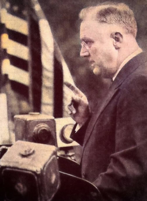 News radio broadcasting in the early 20th century, vintage microphone, man in suit, historic communication technology, archival photo for historical news media, past daily archive.