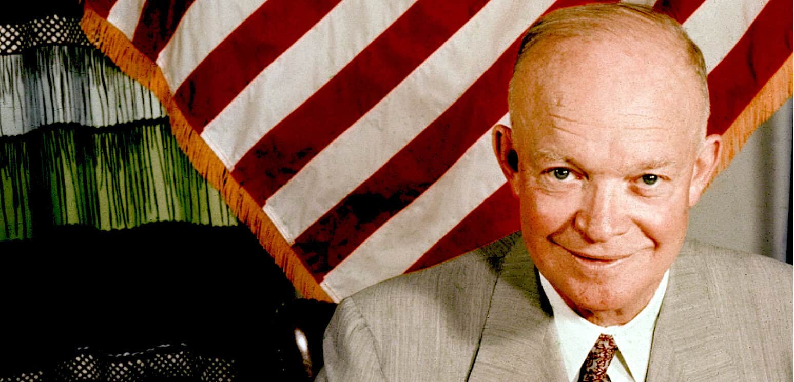 Historic American politician Ronald Reagan, smiling in front of an American flag, former U.S. President, iconic political figure, presidential history, American leadership.