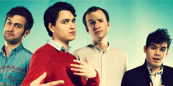 A vintage-inspired photo of four diverse young men posing confidently against a teal background, illustrating themes of music, news, and cultural history.