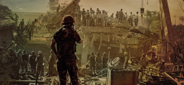 Destroyed building and rescue workers after a disaster scene with emergency responders and debris cleanup.