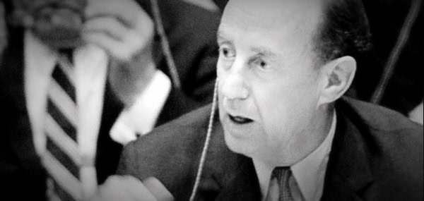 Vintage news radio broadcast featuring a male announcer in a formal suit, capturing historic moments from the Past Daily sound archive.