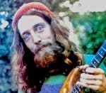 Singer-songwriter with long hair and beard playing guitar outdoors, colorful bokeh background, casual clothing, emphasizing music, nature, and artistic expression for SEO.