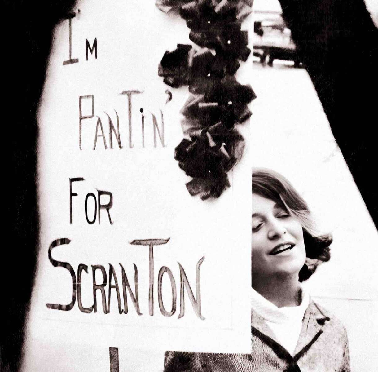 Young woman protesting with a sign that reads "I'M PINTIN' FOR SCRANTON" during a historical demonstration, capturing a moment of activism and social movements important for news and history archives.