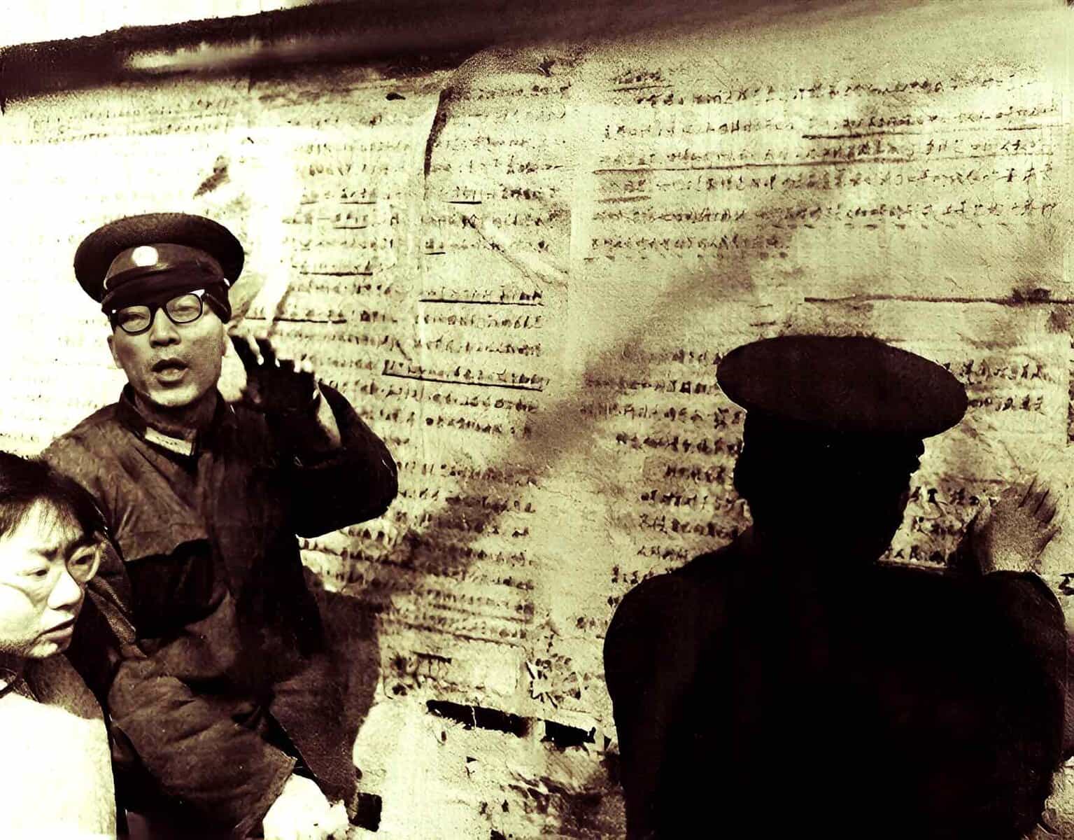 Historic black and white photo of Chinese soldiers, with one man speaking into a microphone, standing in front of ancient script, representing cultural heritage and historical discussions.