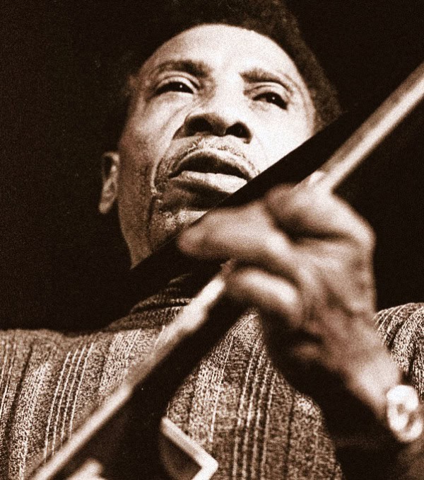 Vintage black and white photo of a jazz musician passionately playing the guitar, capturing the essence of classic music history.