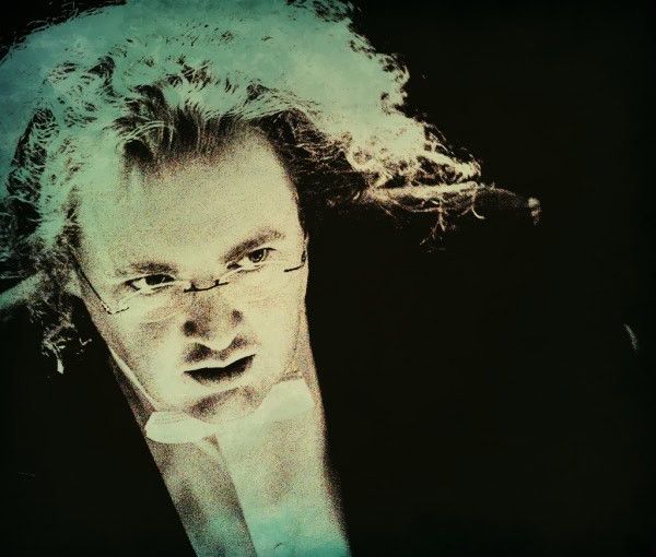 Unique portrait of a classical conductor or musician with flowing gray hair, intense expression, and eyeglasses, emphasizing the themes of music, history, and sound archives for SEO.