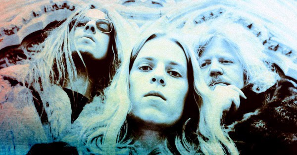 Vintage rock band portrait featuring members with long hair and intense expressions, capturing the essence of classic music history and nostalgia.