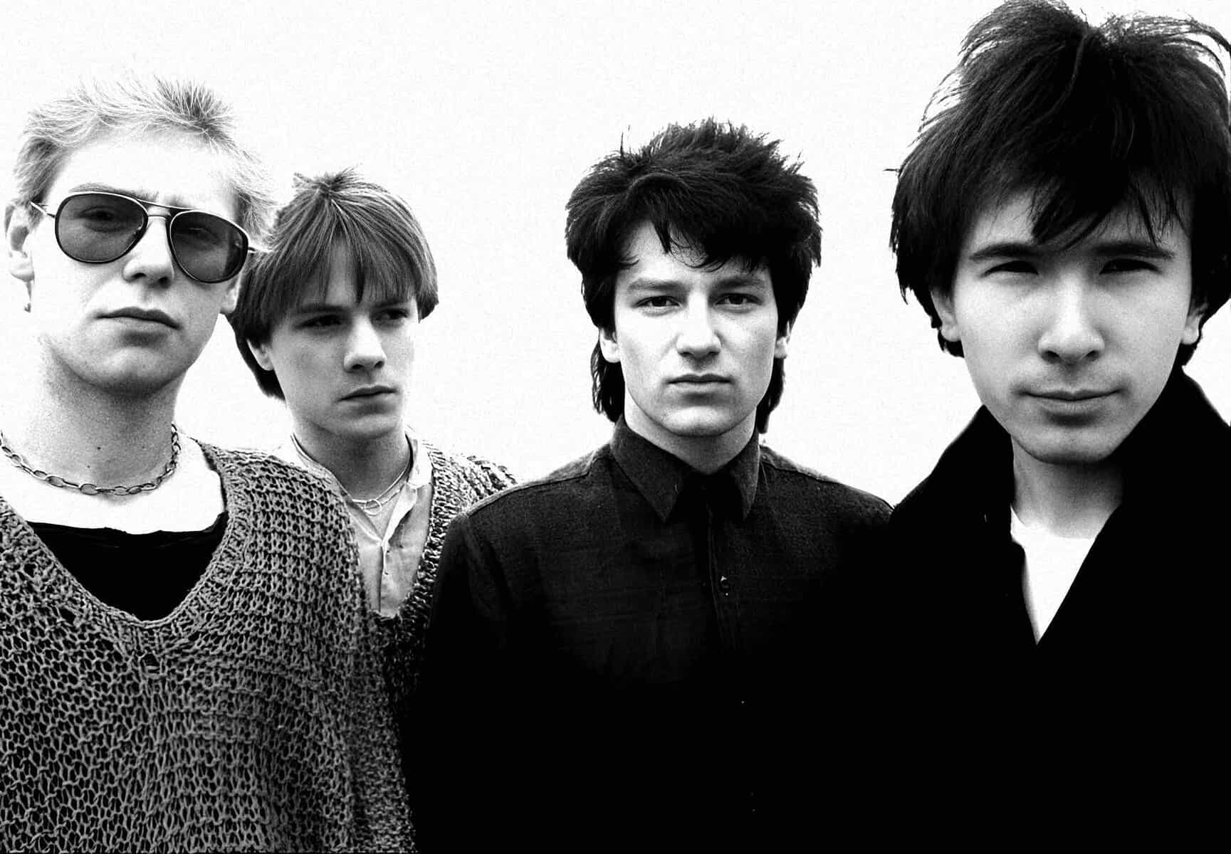 Black and white photo of The Smiths band members, including Morrissey and Johnny Marr, known for influential 1980s alternative rock and indie music.