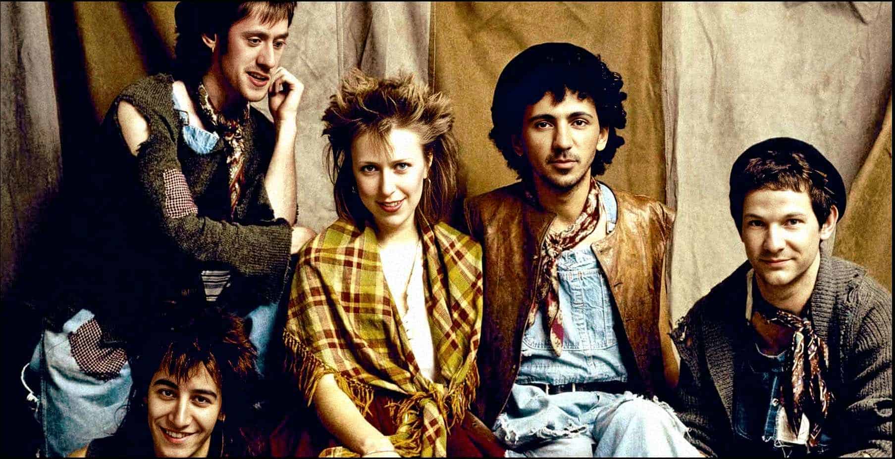 Vintage band photograph featuring diverse young musicians with a retro style, in a studio setting, highlighting music history and indie culture, aligned with archives of news, history, and music.