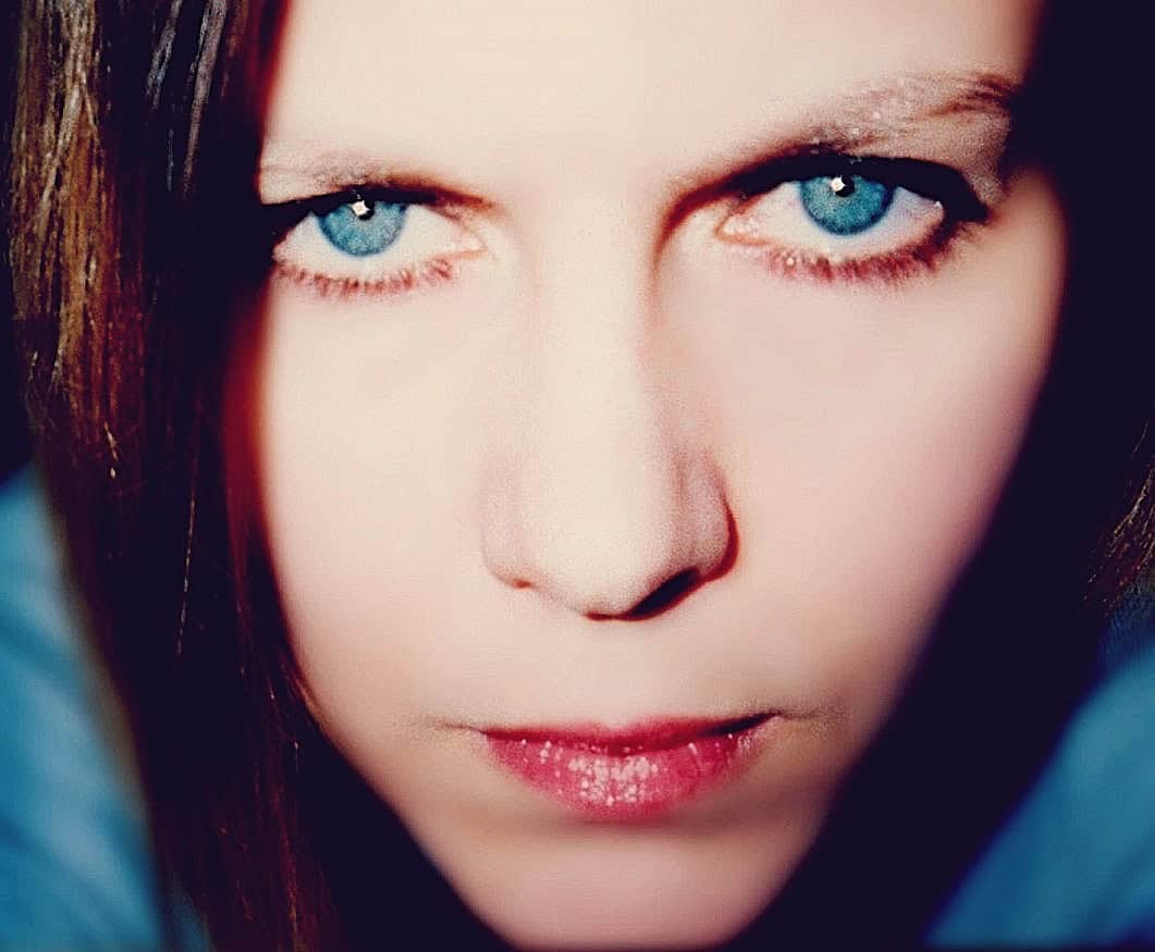 Close-up portrait of a young woman with striking blue eyes, highlighting beauty, fashion, and personal style. Perfect for images related to beauty photography, fashion, or lifestyle content.