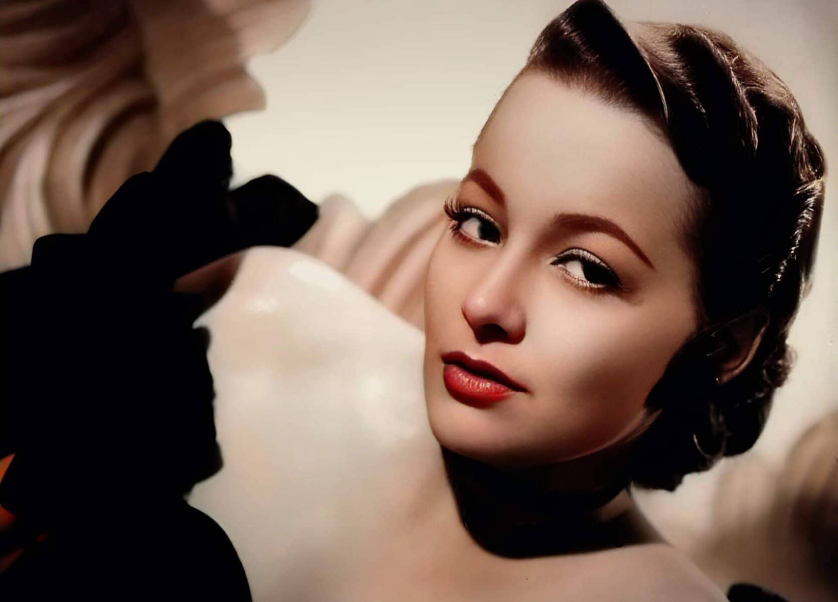 Portrait of a glamorous woman with vintage hairstyle and makeup, showcasing classic beauty and elegance, representing the nostalgic sound archive of news, history, and music at Past Daily.