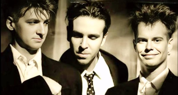 Band of young men in formal attire black-and-white portrait, nostalgic musical scene, retro style, vintage vibe, 1980s music band, classic rock, musical history, iconic band photograph, timeless music group image.