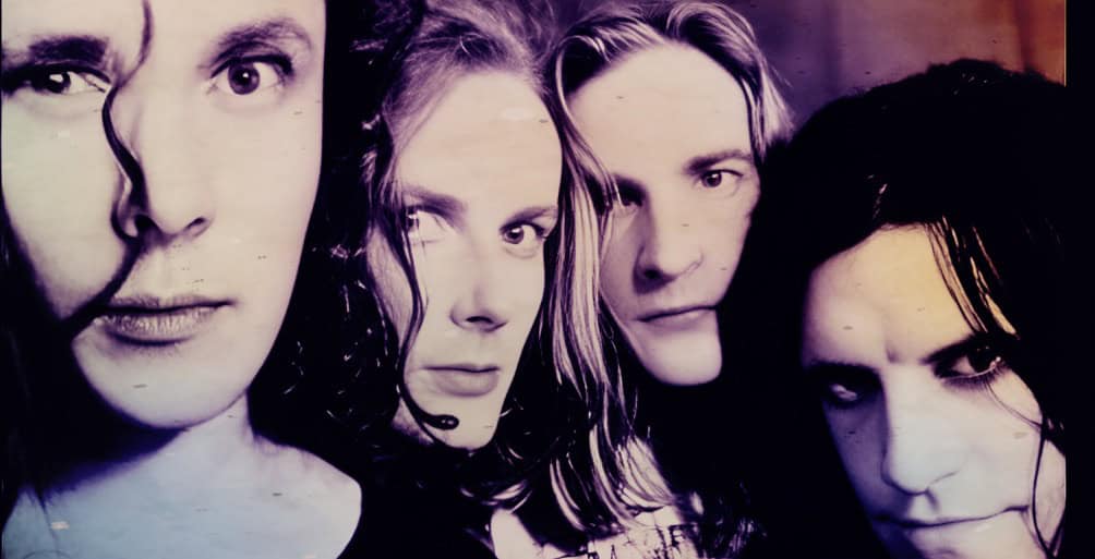 Close-up of a rock band with intense expressions, showcasing music and historical sound archives, focusing on news, music history, and vintage recordings from Past Daily.