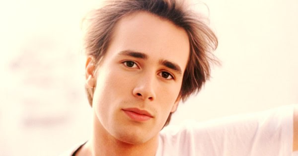 High school student listening to vintage music at home, representing archive audio and history preservation.