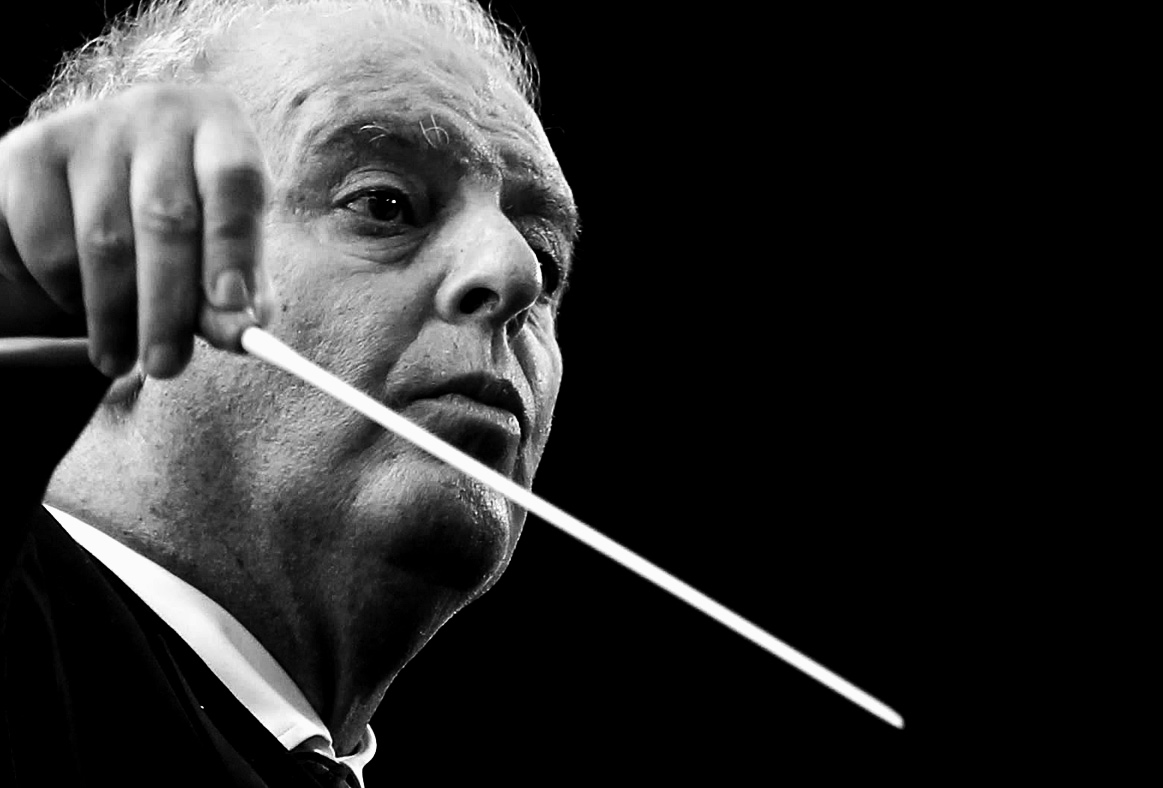 A black and white close-up of a conductor with an intense focus, holding a baton during a classical music performance, representing historical music moments and sound archives.