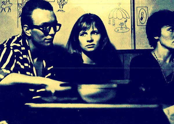 Vintage black-and-white photo of three women sitting at a table in a cozy, retro cafe or diner, reflecting history and cultural moments; ideal for articles on news archives, history, and music.