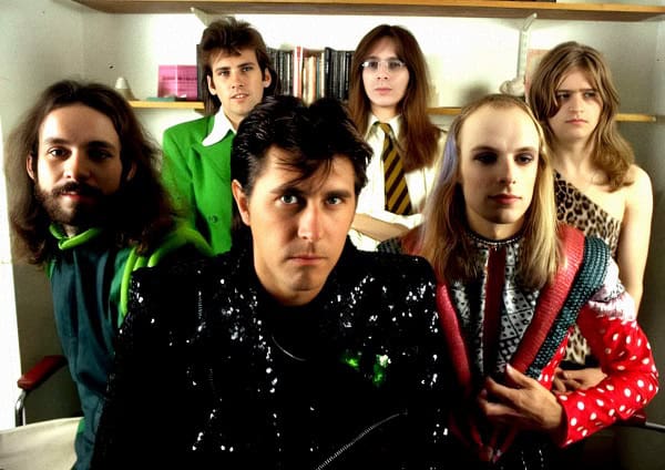 Past daily sound archive of news history music band group photo, rock band with diverse members in casual and vintage style, music history, entertainment, cultural archive, music enthusiasts.