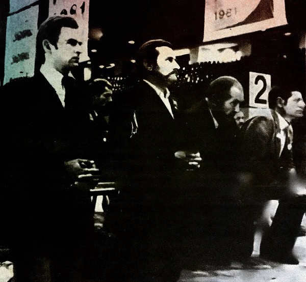 Retro news event photograph featuring attentive individuals at a historic conference or meeting.