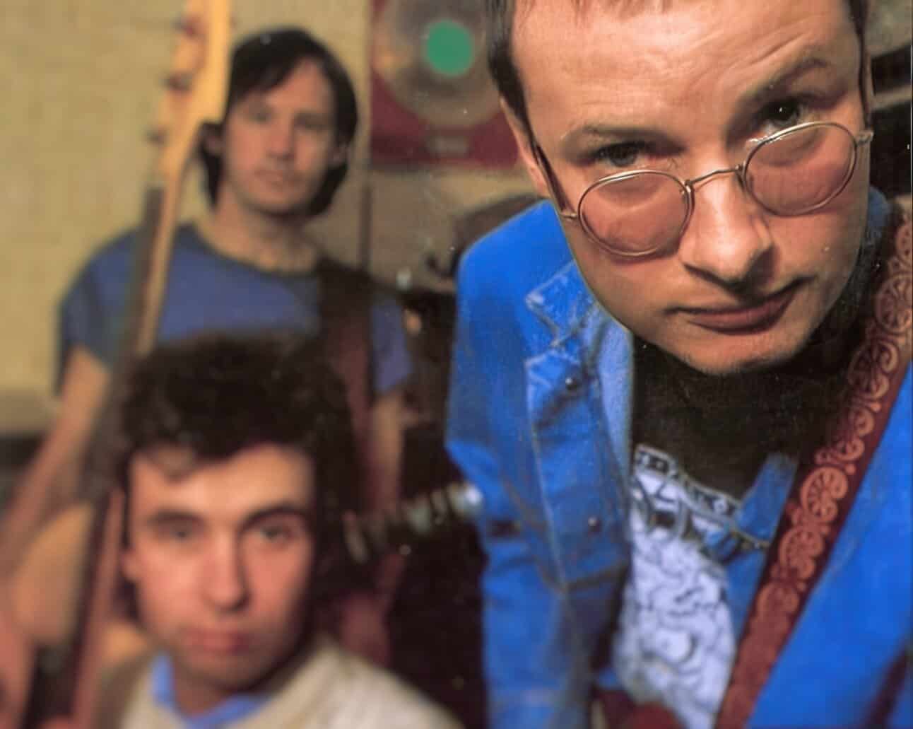 Mysterious men with musical instruments, vintage music scene, nostalgic sound archive, classic rock band in casual attire, retro music history, Past Daily archive image.
