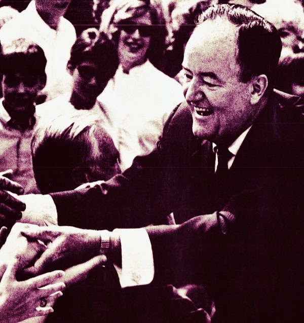 JFK greeting supporters at a historic event, capturing a moment of political significance and public engagement.