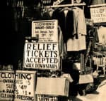 Clothing sale and relief tickets sign at a vintage marketplace, showcasing historical shopping ads and community aid efforts.