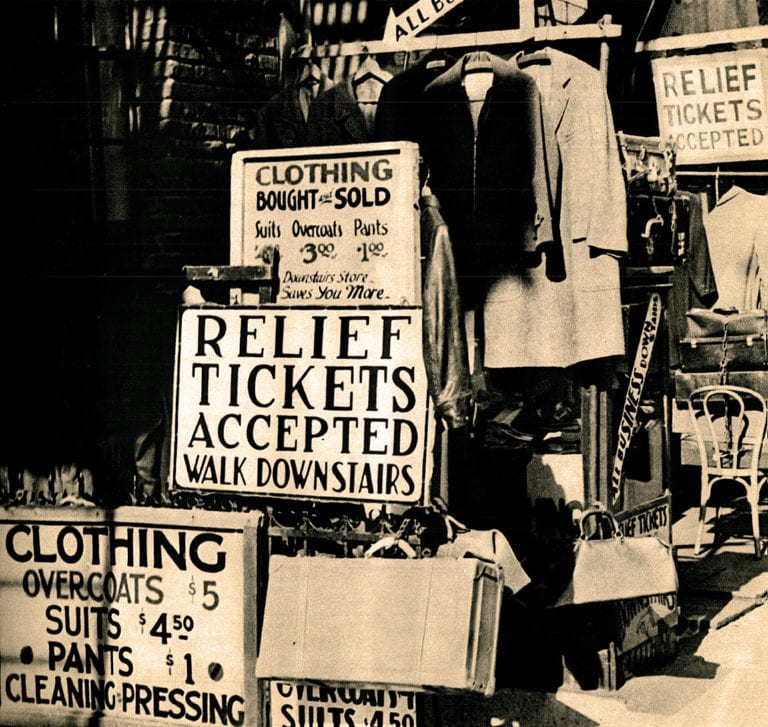 Clothing sale and relief tickets sign at a vintage marketplace, showcasing historical shopping ads and community aid efforts.