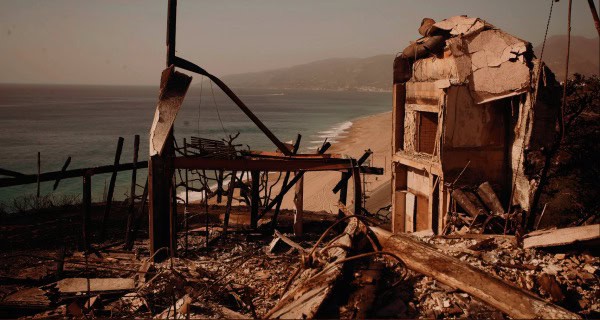 Damaged building with debris and wreckage near the coast after a natural disaster, illustrating destruction, ruins, and the impact of earthquakes or storms on local infrastructure.