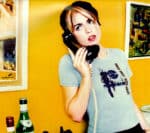 Phone receiver, young woman with short hair, casual t-shirt, listening to a vintage corded telephone, colorful art background, retro aesthetic, music and news archive theme, Past Daily, sound archive of news, history, and music.