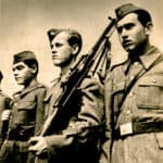 Historical military soldiers in uniform with rifles, representing wartime history and military service, from the archives of Past Daily.