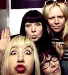 Retro women group taking a playful selfie, lively portrait capturing fun, friendship, and music history moments, ideal for nostalgia and pop culture content.
