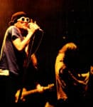 Vintage photo of musicians performing at a live concert for a sound archive of news, history, and music on Past Daily. Focus on classic rock and music history.