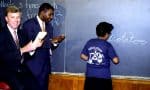 Historic classroom scene with teachers and a student writing "potato" on a blackboard, illustrating educational activities, nostalgic learning environment, and classroom teaching moments.