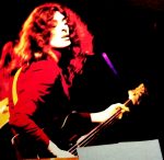 Guitarist performing live at a music event, capturing the essence of classic rock and musical history for archive and nostalgic purposes.