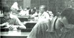 Newspaper Archives in a Library, Historical News, Newsreading, Researchers, Old News Collection, News History, Media Library, Vintage Newsroom, News Documentation, Historical Record-keeping.