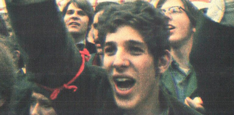 Young woman protesting at a rally, expressing emotions of passion and activism, surrounded by diverse crowd, capturing the spirit of social movements, news, and history coverage.