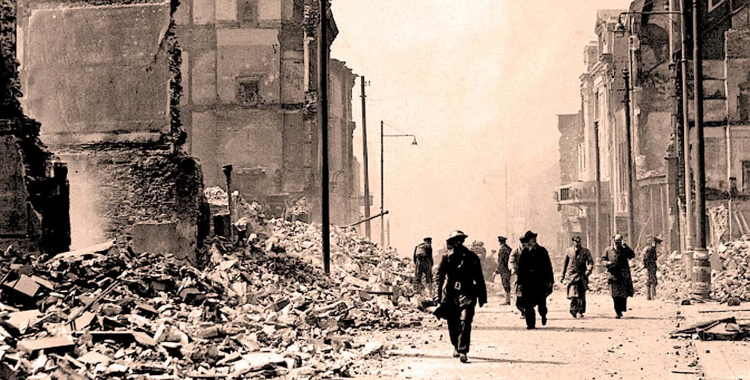 Collapsed buildings and debris after a disaster with historic city street scene, illustrating news coverage, history, and recovery efforts.