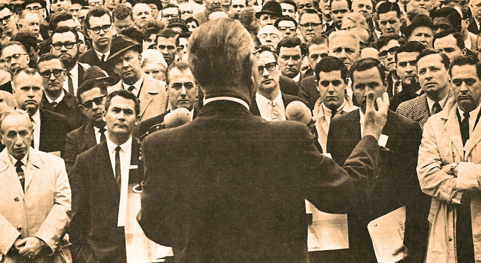 History of civil rights movement, Martin Luther King Jr. speech, vintage black and white photo of famous activist addressing a crowd, significant moments in American history, past daily archives of news and cultural events.