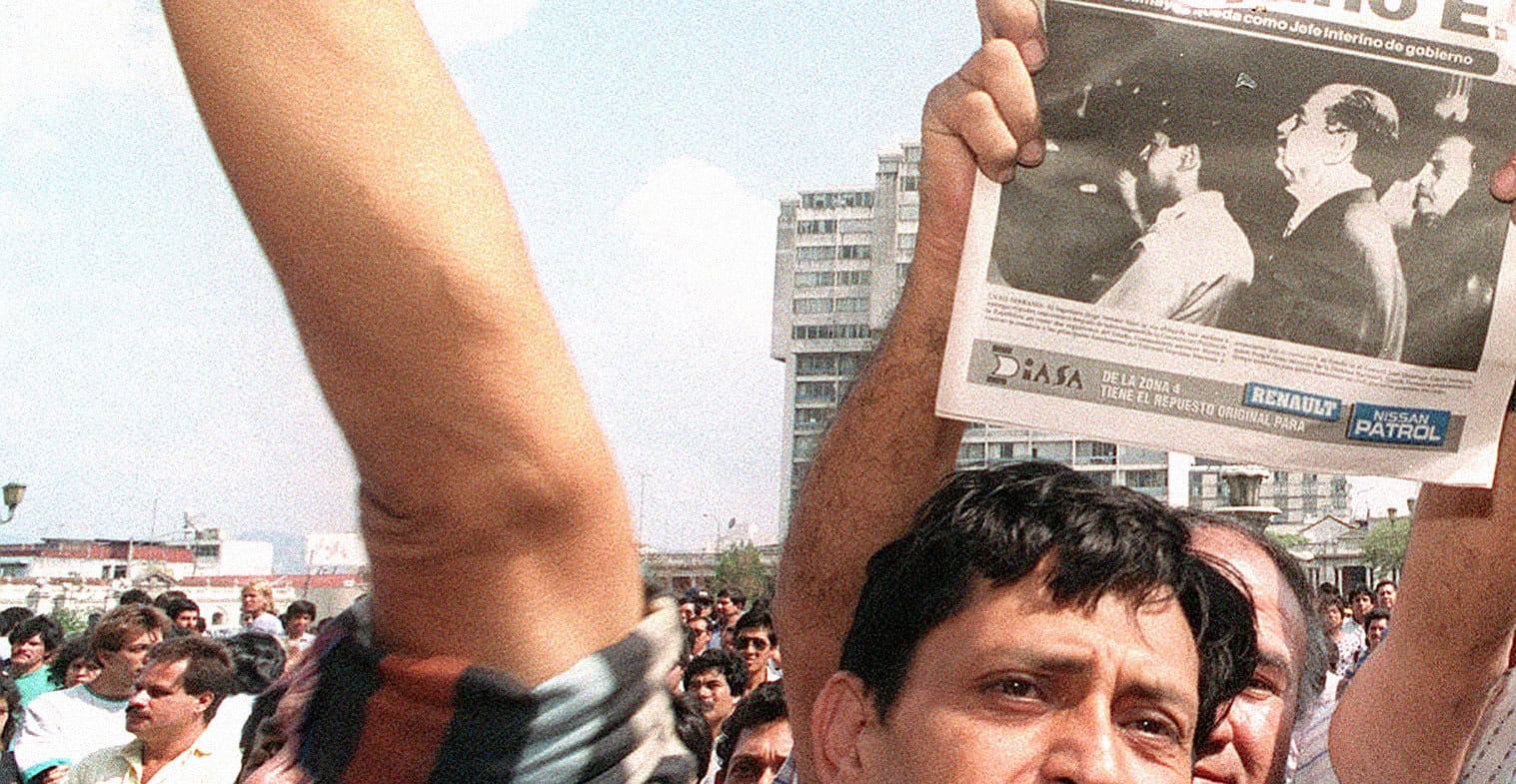 People holding vintage newspapers during a public gathering or protest, showcasing historical moments captured in news archives, relevant to news, history, and music archives.