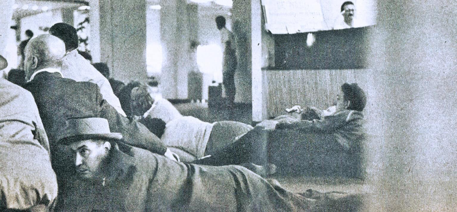 People resting on the floor during a historical event at Past Daily archive.
