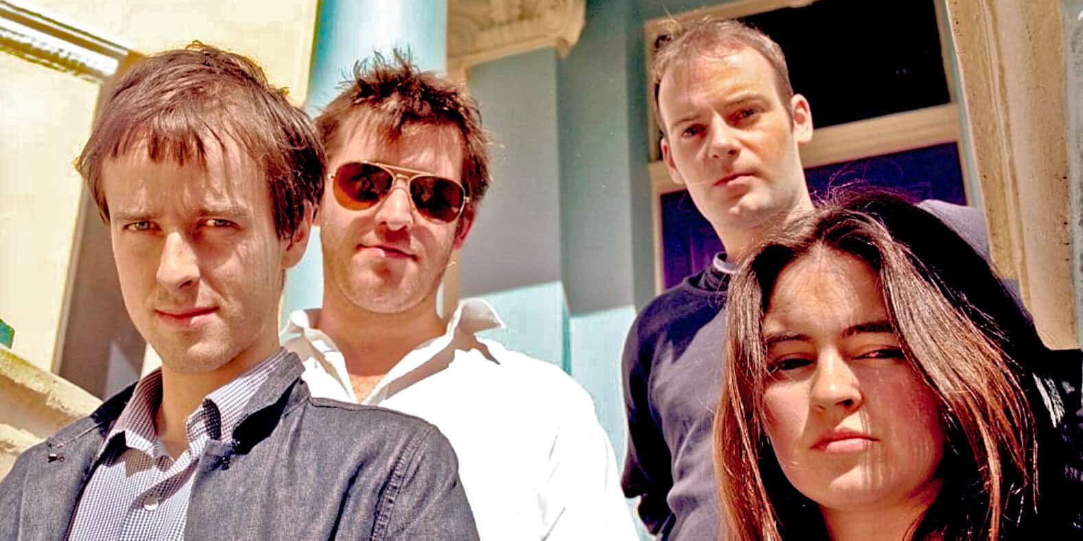 A multimedia image of a band with four members posing outdoors, capturing a sense of music, news, and history. Ideal for illustrating classic rock or alternative music scenes on a sound archive website.