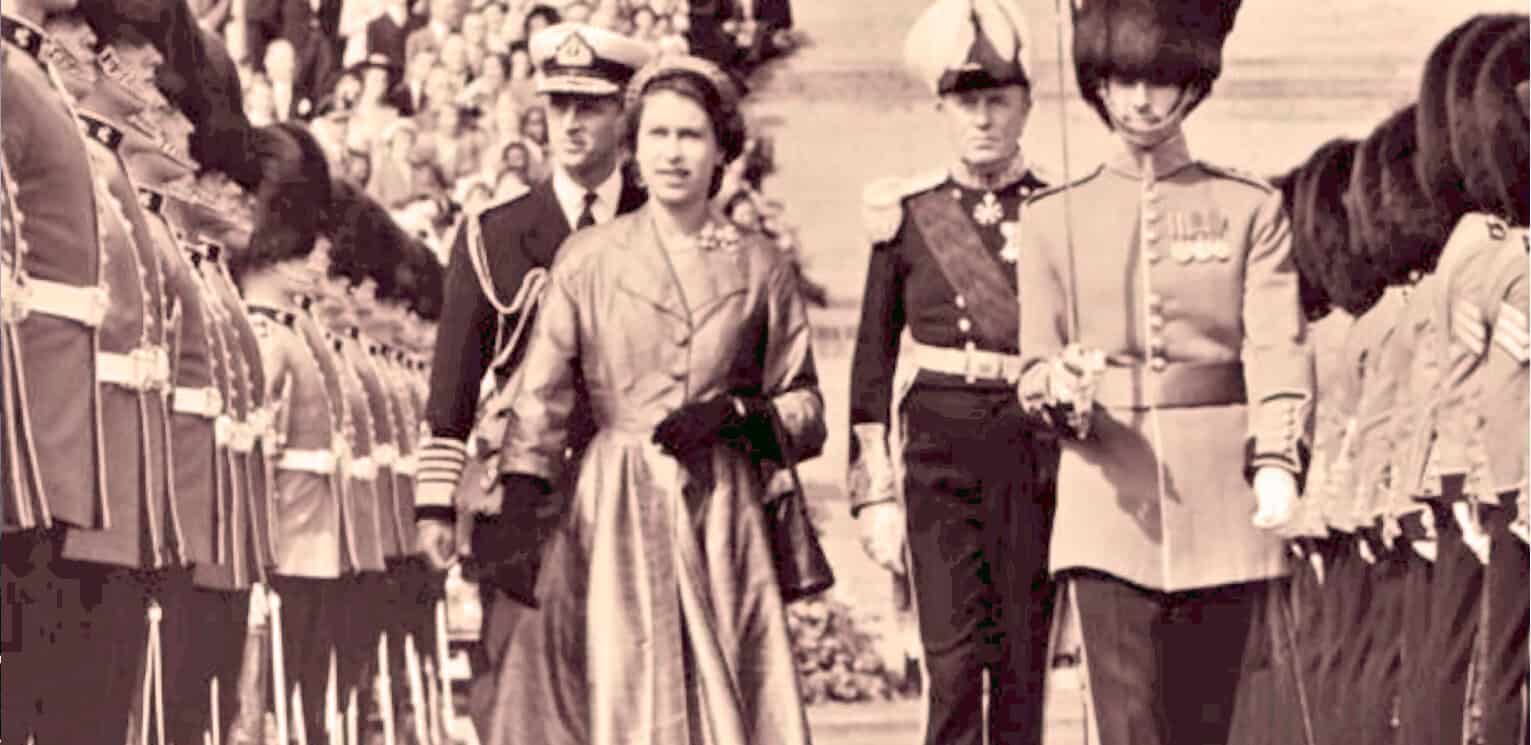 Historic military parade featuring soldiers and civilians, vintage black and white photo capturing a moment of historical significance, part of Past Daily's sound archive of news, history, and music.