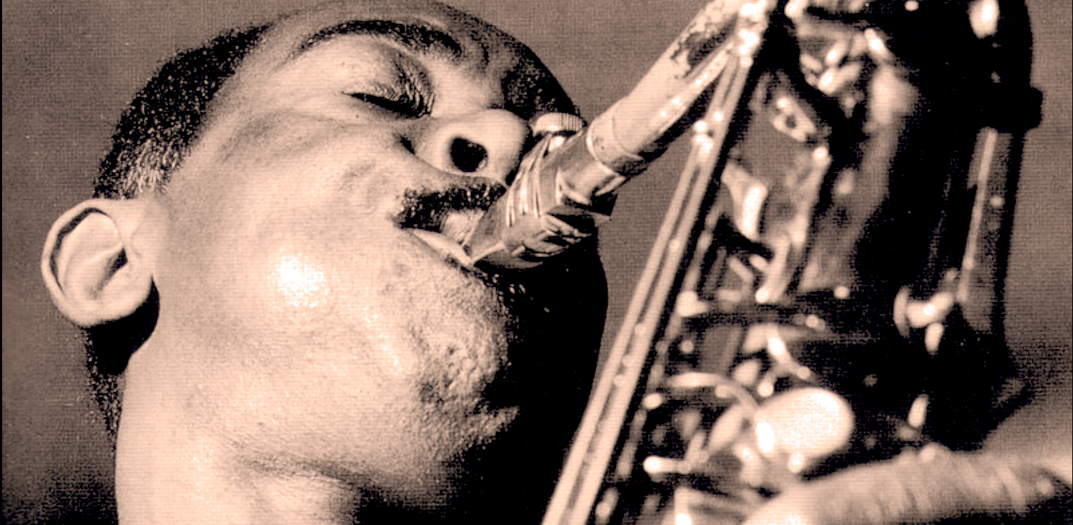 Saxophonist playing jazz music, vintage black and white photo, jazz music history, iconic jazz musician performance, classic jazz archive image.