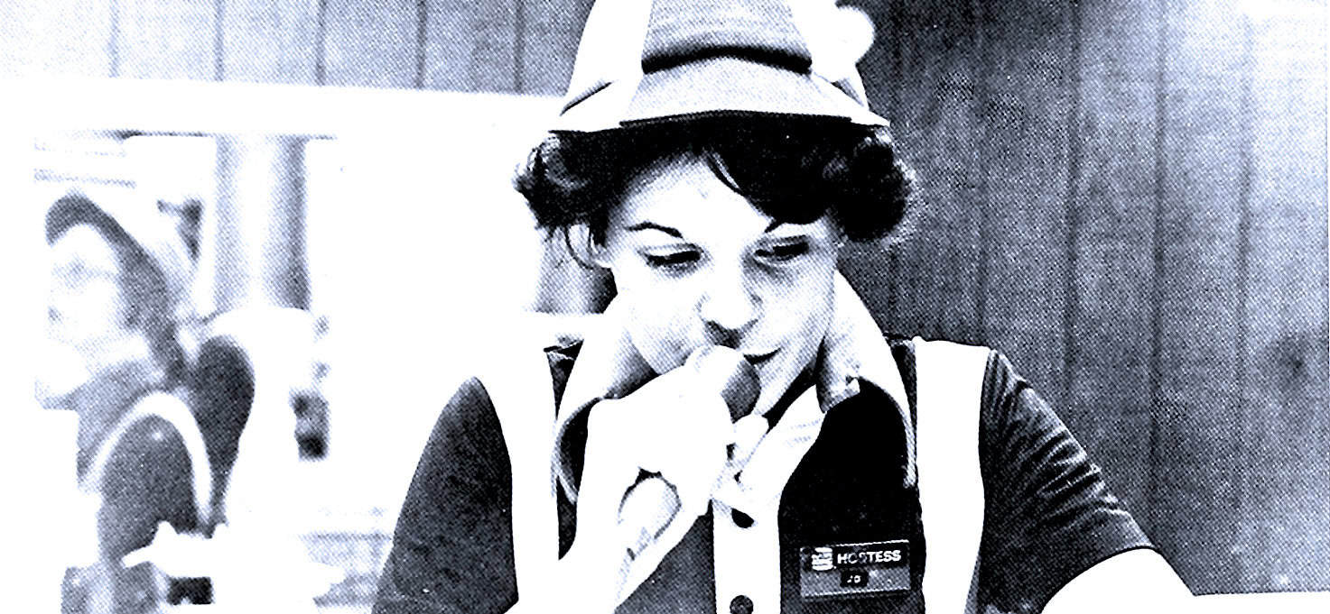 Vintage woman in uniform speaking into a microphone at a news event capturing historical and news archive moments.