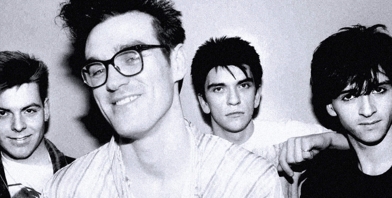 Young men with 80s hairstyles, representing a classic rock or pop band, in black and white.