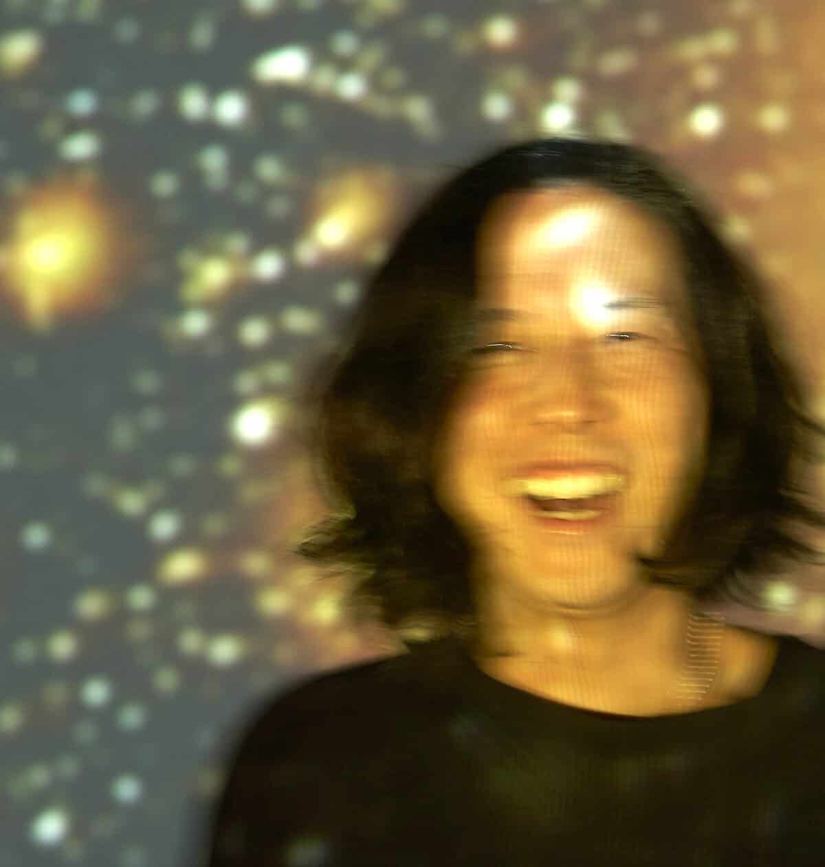 Laughing woman enjoying music and news archive visuals at Past Daily sound archive of news, history, and music event.