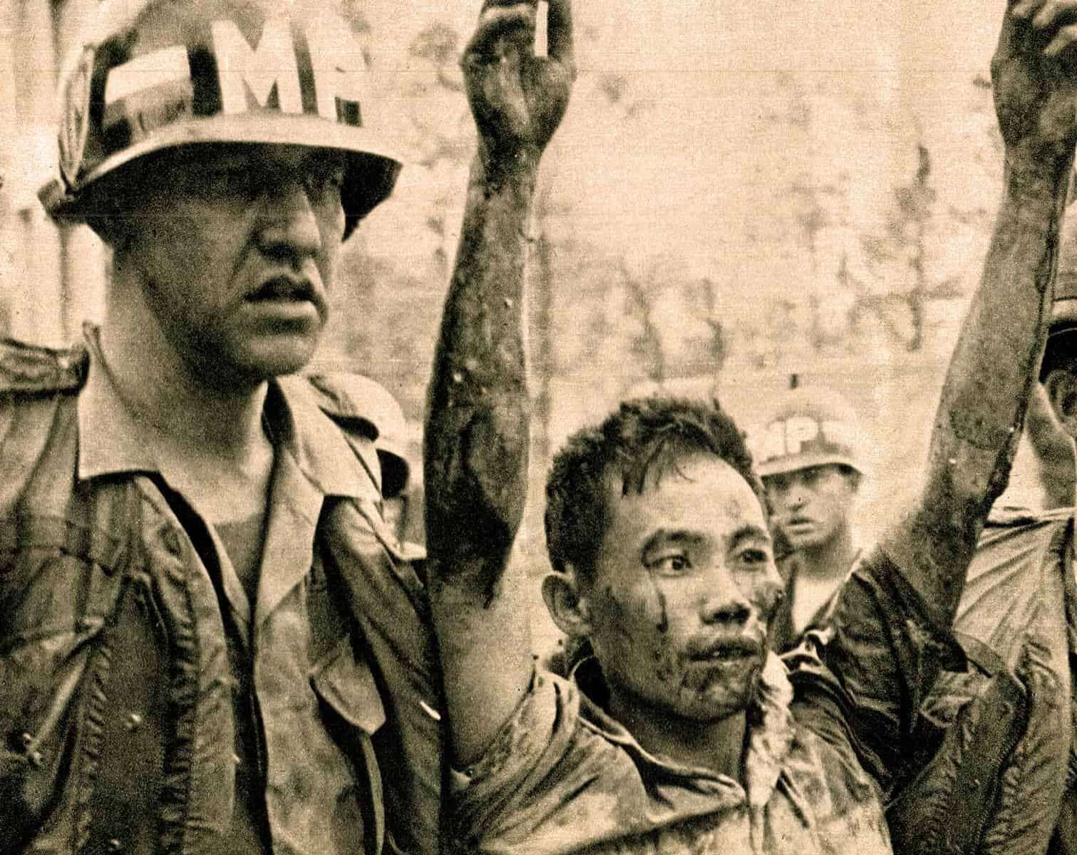 Vietnam War soldiers raising their fists in a moment of unity and resilience, capturing a historic event with a focus on news, history, and music archives.