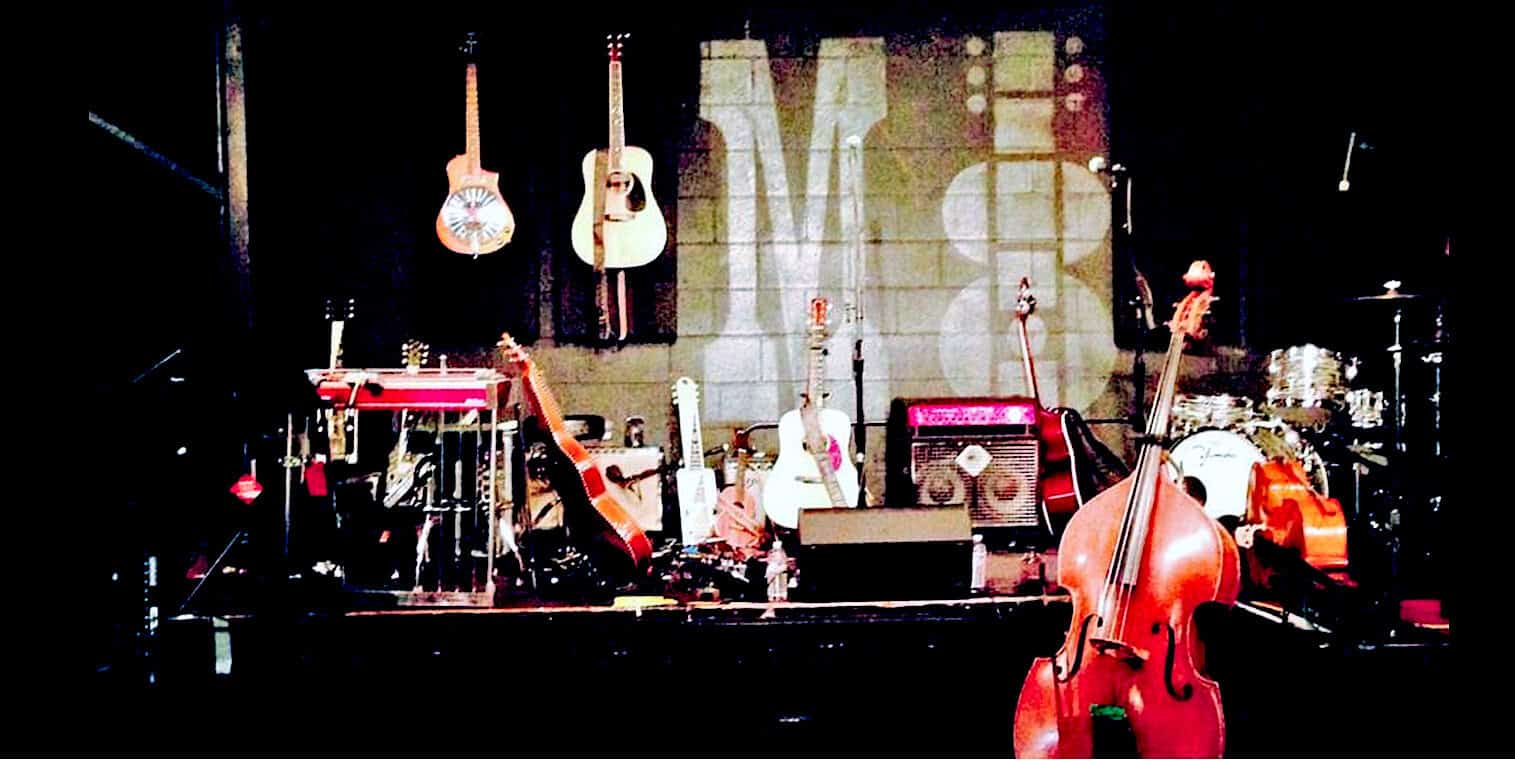 Vintage musical instruments and stage setup for live performance at Past Daily, a sound archive of news, history, and music.