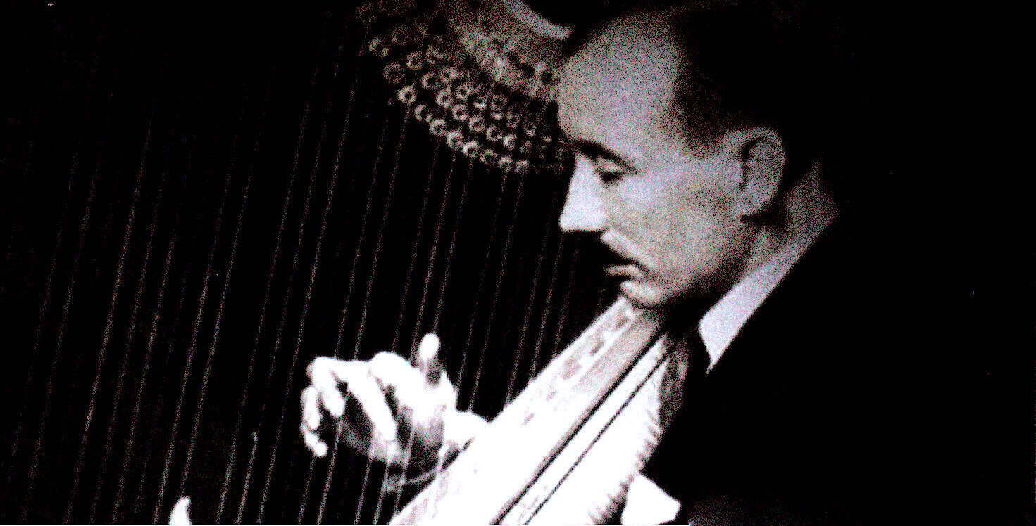Vintage black and white photo of a man playing a vibraphone, capturing a classic jazz musician at a historic sound archive dedicated to news, history, and music recordings.