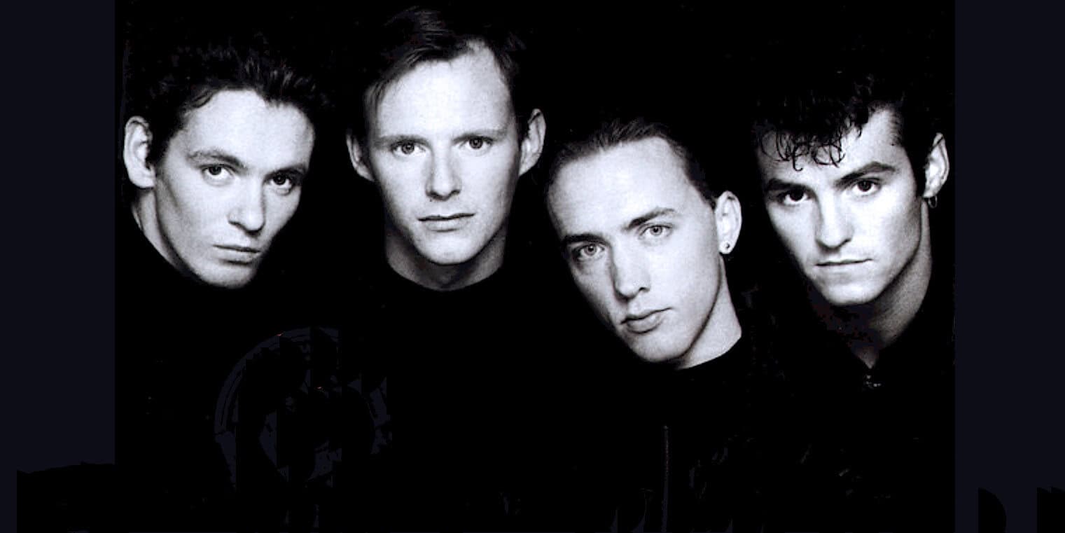 Young men with vibrant hairstyles in black and white image, representing music and pop culture history from Past Daily archives.